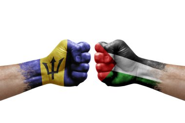Two hands punch to each others on white background. Country flags painted fists, conflict crisis concept between barbados and palestine