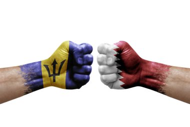 Two hands punch to each others on white background. Country flags painted fists, conflict crisis concept between barbados and qatar