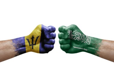 Two hands punch to each others on white background. Country flags painted fists, conflict crisis concept between barbados and saudi arabia