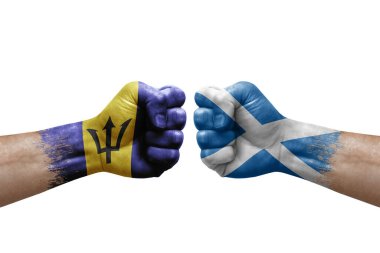 Two hands punch to each others on white background. Country flags painted fists, conflict crisis concept between barbados and scotland