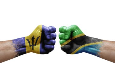 Two hands punch to each others on white background. Country flags painted fists, conflict crisis concept between barbados and tanzania