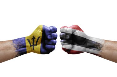 Two hands punch to each others on white background. Country flags painted fists, conflict crisis concept between barbados and thailand