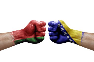 Two hands punch to each others on white background. Country flags painted fists, conflict crisis concept between belarus and bosnia