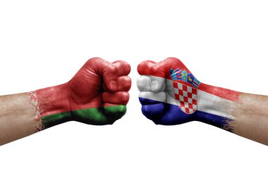 Two hands punch to each others on white background. Country flags painted fists, conflict crisis concept between belarus and croatia