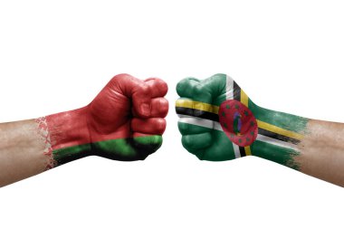 Two hands punch to each others on white background. Country flags painted fists, conflict crisis concept between belarus and dominica