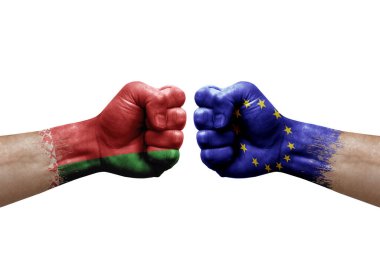 Two hands punch to each others on white background. Country flags painted fists, conflict crisis concept between belarus and european union