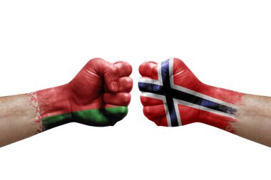 Two hands punch to each others on white background. Country flags painted fists, conflict crisis concept between belarus and norway