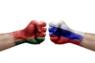 Two hands punch to each others on white background. Country flags painted fists, conflict crisis concept between belarus and russia