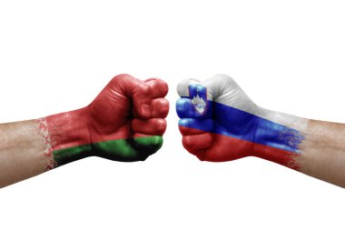 Two hands punch to each others on white background. Country flags painted fists, conflict crisis concept between belarus and slovenia