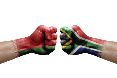 Two hands punch to each others on white background. Country flags painted fists, conflict crisis concept between belarus and south africa