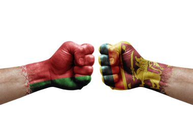 Two hands punch to each others on white background. Country flags painted fists, conflict crisis concept between belarus and sri lanka