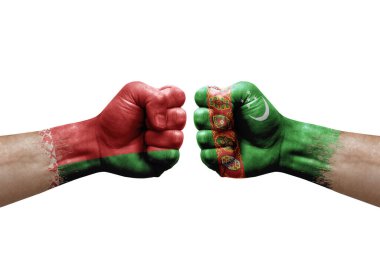 Two hands punch to each others on white background. Country flags painted fists, conflict crisis concept between belarus and turkmenistan