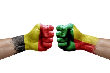 Two hands punch to each others on white background. Country flags painted fists, conflict crisis concept between belgium and benin