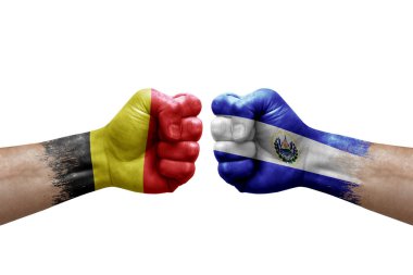 Two hands punch to each others on white background. Country flags painted fists, conflict crisis concept between belgium and el salvador