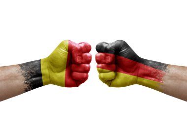 Two hands punch to each others on white background. Country flags painted fists, conflict crisis concept between belgium and germany