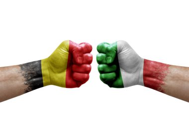 Two hands punch to each others on white background. Country flags painted fists, conflict crisis concept between belgium and italy