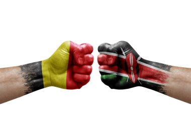 Two hands punch to each others on white background. Country flags painted fists, conflict crisis concept between belgium and kenya