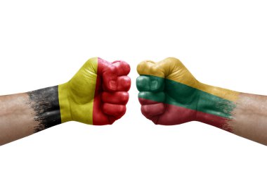 Two hands punch to each others on white background. Country flags painted fists, conflict crisis concept between belgium and lithuania