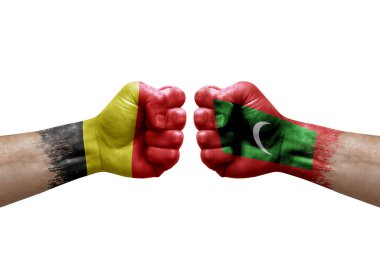 Two hands punch to each others on white background. Country flags painted fists, conflict crisis concept between belgium and maldives