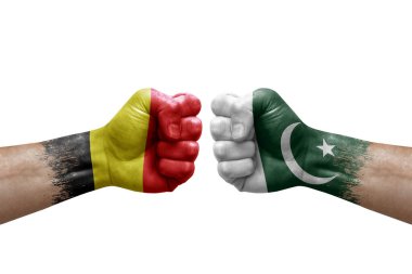 Two hands punch to each others on white background. Country flags painted fists, conflict crisis concept between belgium and pakistan