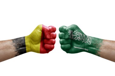 Two hands punch to each others on white background. Country flags painted fists, conflict crisis concept between belgium and saudi arabia