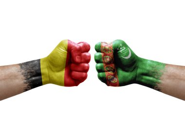 Two hands punch to each others on white background. Country flags painted fists, conflict crisis concept between belgium and turkmenistan