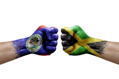 Two hands punch to each others on white background. Country flags painted fists, conflict crisis concept between belize and jamaica
