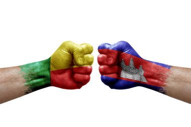 Two hands punch to each others on white background. Country flags painted fists, conflict crisis concept between benin and cambodia