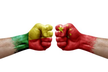 Two hands punch to each others on white background. Country flags painted fists, conflict crisis concept between benin and china