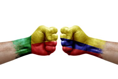 Two hands punch to each others on white background. Country flags painted fists, conflict crisis concept between benin and colombia
