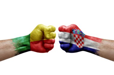 Two hands punch to each others on white background. Country flags painted fists, conflict crisis concept between benin and croatia