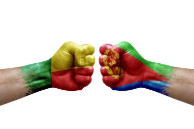 Two hands punch to each others on white background. Country flags painted fists, conflict crisis concept between benin and eritrea