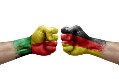 Two hands punch to each others on white background. Country flags painted fists, conflict crisis concept between benin and germany