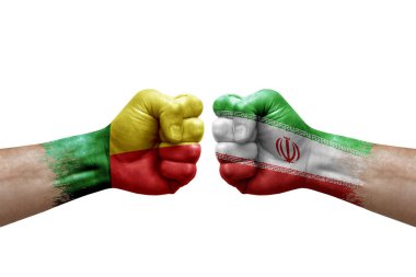 Two hands punch to each others on white background. Country flags painted fists, conflict crisis concept between benin and iran