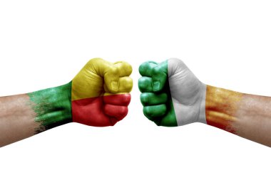Two hands punch to each others on white background. Country flags painted fists, conflict crisis concept between benin and ireland