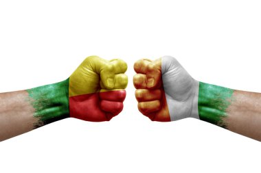 Two hands punch to each others on white background. Country flags painted fists, conflict crisis concept between benin and ivory coast