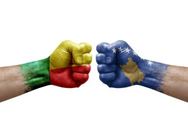 Two hands punch to each others on white background. Country flags painted fists, conflict crisis concept between benin and kosovo