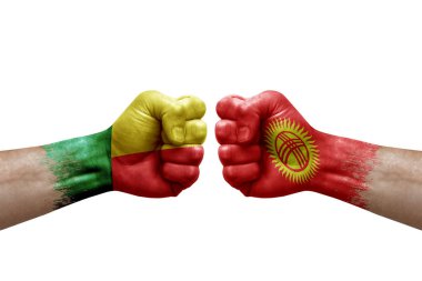 Two hands punch to each others on white background. Country flags painted fists, conflict crisis concept between benin and kyrgyzstan