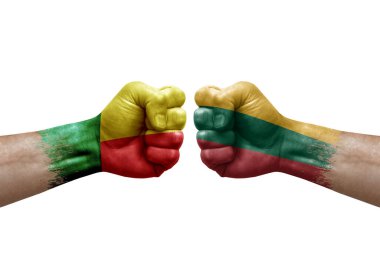 Two hands punch to each others on white background. Country flags painted fists, conflict crisis concept between benin and lithuania