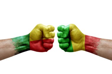 Two hands punch to each others on white background. Country flags painted fists, conflict crisis concept between benin and mali