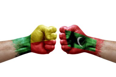 Two hands punch to each others on white background. Country flags painted fists, conflict crisis concept between benin and maldives