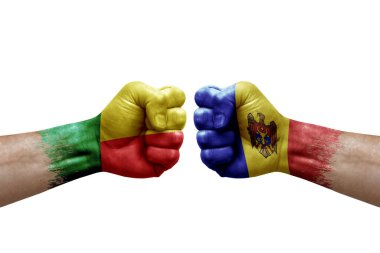 Two hands punch to each others on white background. Country flags painted fists, conflict crisis concept between benin and moldova