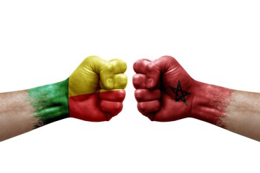 Two hands punch to each others on white background. Country flags painted fists, conflict crisis concept between benin and morocco