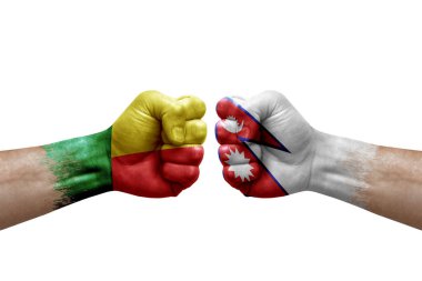 Two hands punch to each others on white background. Country flags painted fists, conflict crisis concept between benin and nepal