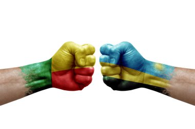 Two hands punch to each others on white background. Country flags painted fists, conflict crisis concept between benin and rwanda
