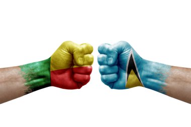 Two hands punch to each others on white background. Country flags painted fists, conflict crisis concept between benin and saint lucia