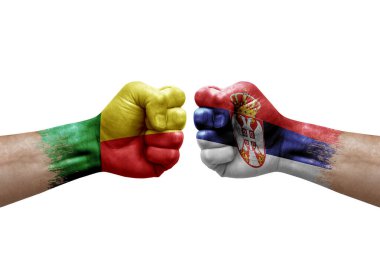Two hands punch to each others on white background. Country flags painted fists, conflict crisis concept between benin and serbia
