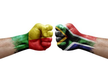 Two hands punch to each others on white background. Country flags painted fists, conflict crisis concept between benin and south africa
