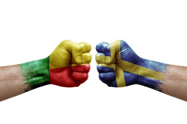 Two hands punch to each others on white background. Country flags painted fists, conflict crisis concept between benin and sweden