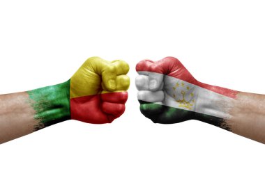 Two hands punch to each others on white background. Country flags painted fists, conflict crisis concept between benin and tajikistan